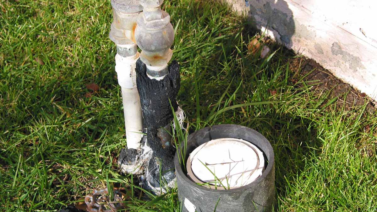 An example of a pool clean-out port in a yard.